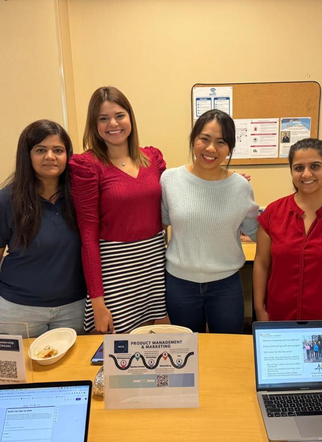 Anuja Gupta with three MBA students in a classroom