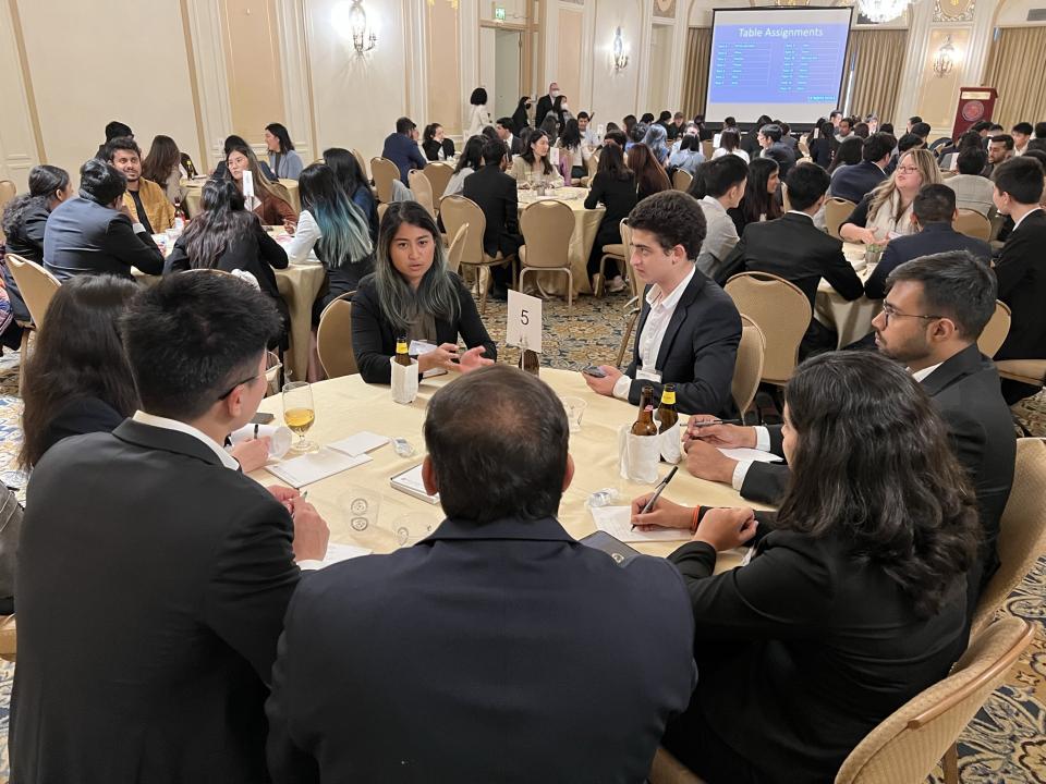 group of people sitting at a round table