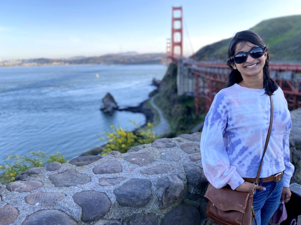 Woman standing in front of the Golden Gate bridge in San Francisco