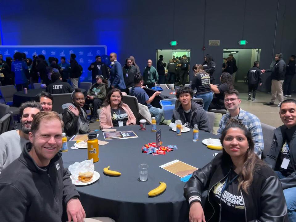 a group of MBA students seated at a round table