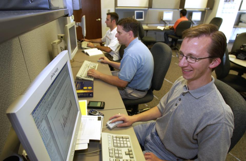 Three MBA students in a computer lab