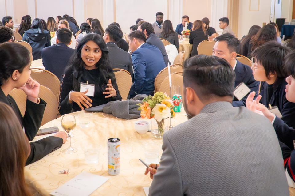 Jyothica Monan speaking to a table of students during the Speed Networking Event