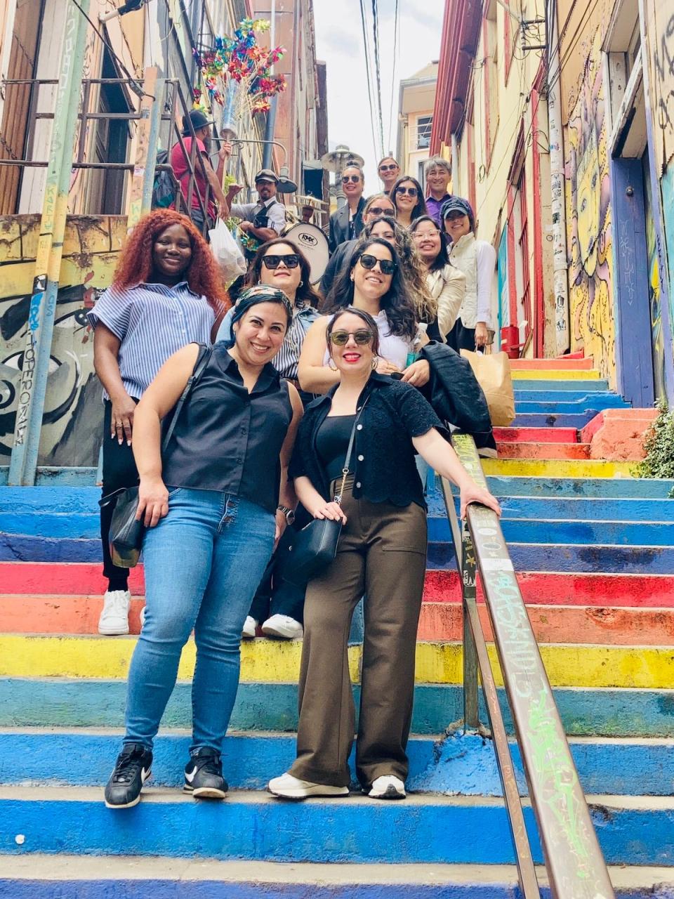 MBA students in Chile, standing on a colorful outdoor staircase