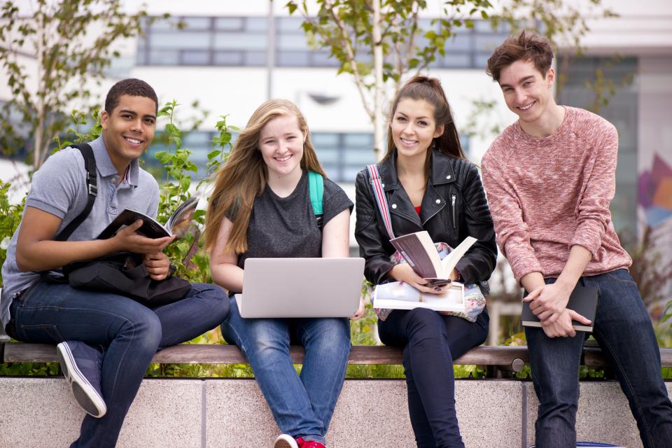 college students sitting on a bench