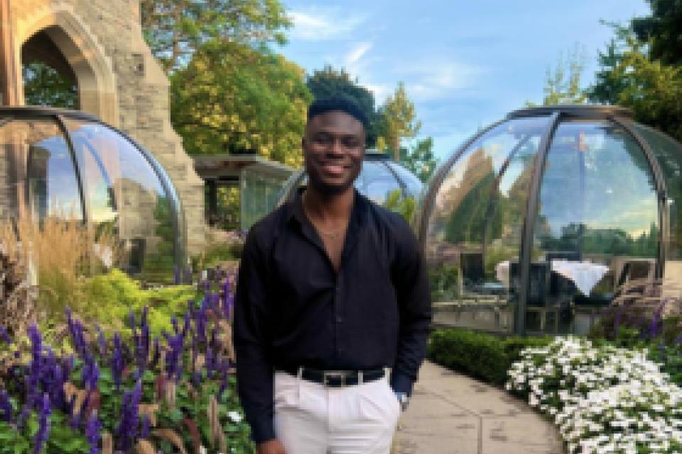 Lanre Akinfemiwa standing in a garden