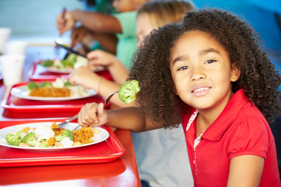 girl eating broccoli