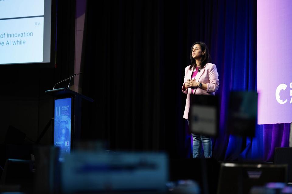 Shilpi Sharma on stage at a conference